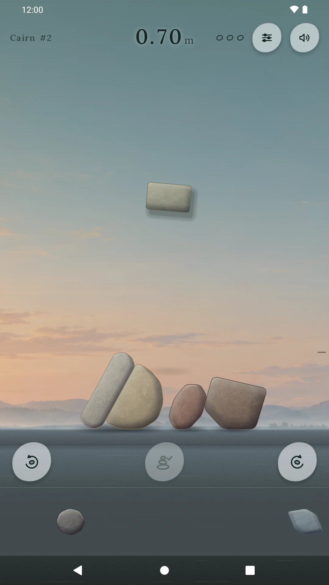 Actual Cairn gameplay: a stone held above a partially built tower
